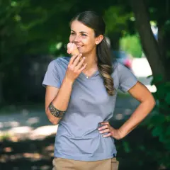 Frau genießt ein Eis im Sommer, trägt ein Shirt aus **Merinowolle im Sommer**.