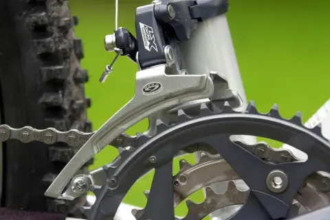 Nahaufnahme des Umwerfers und der Kettenblätter eines Fahrrads. Hier wird die **Gangschaltung Fahrrad einstellen** für eine reibungslose Fahrt.