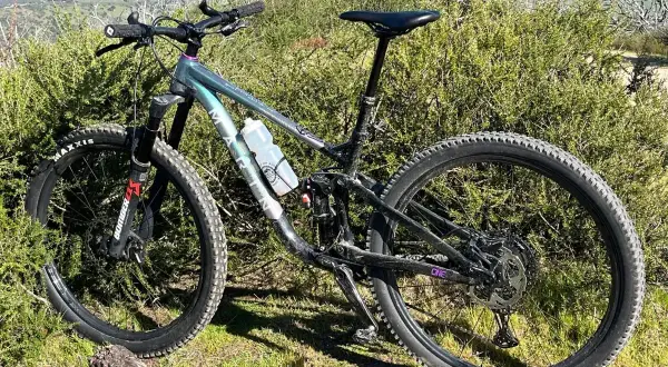 Ein Mountainbike steht im Grünen. Es ist bereit für Abenteuer, vielleicht sogar für eine Runde Cyclocross, wo solche robusten Räder ihre Stärken ausspielen.