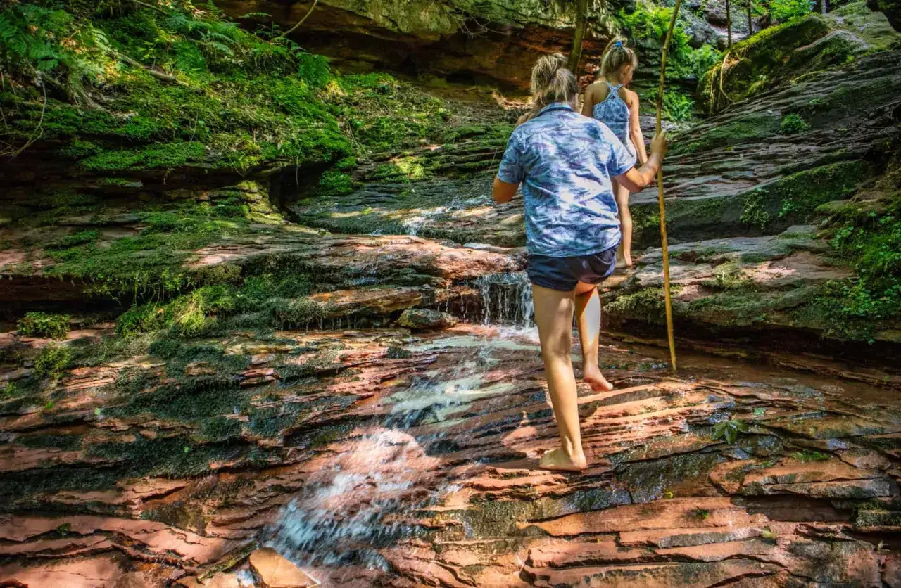 Zwei M&auml;dchen erkunden einen Bachlauf im Wald. Ein echter Geheimtipp Wandern Schwarzwald f&uuml;r Abenteuerlustige.